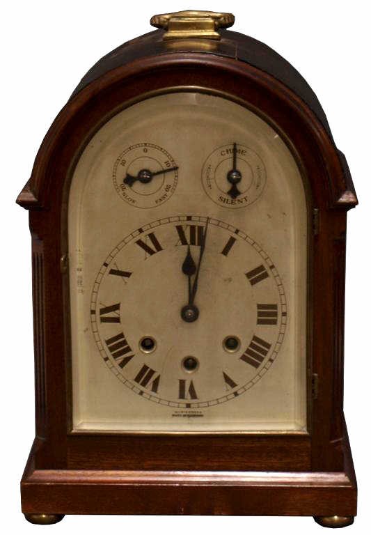 GERMAN CHIMING BRACKET CLOCK, WURTEMBERG: German mahogany finish chiming bracket clock, marked "Wurtemberg, Made In Germany", c. 1920, beveled glass door over clock face with regulator and chime/silent dial, some veneer loss, 14"h, 9.5"w, 7"d