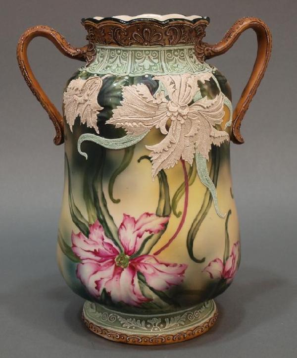 VERY FINE NIPPON MORIAGE PORCELAIN HANDLED VASE: Nippon porcelain moriage decorated handled vase, early 20th c., a fine example with moriage and polychrome hand painted floral scenes, blue maple leaf mark underfoot, no chips/cracks noted under black