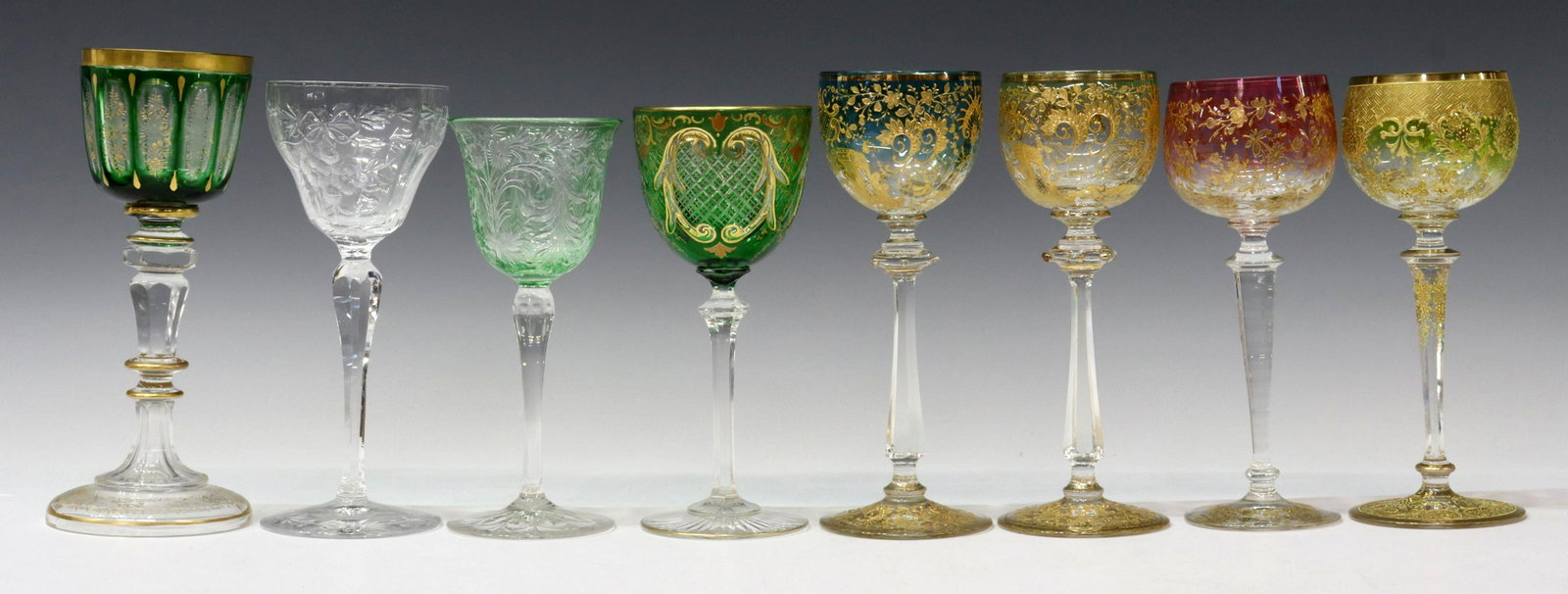 (8) BOHEMIAN PARCEL GILT & CUT-TO-CLEAR STEMWARE: (lot of 8) Bohemian stemware, comprising a variety of colored, flashed, cut-to-clear, parcel gilt enameled, and cut hock and wine glasses, (one) intact with fracture to bowl, largest: approx 7.75"h, 3