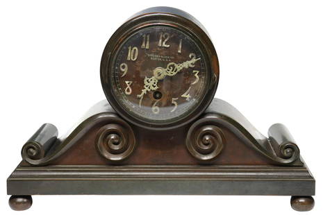 AMERICAN CHELSEA CLOCK CO. TAMBOUR SHELF CLOCK: American mantel shelf clock, Chelsea Clock Company, Boston, early 20th c., tambour style case, housing dial with raised Arabic numeral hour markers, time-only movement, scrolled ends, rising on four