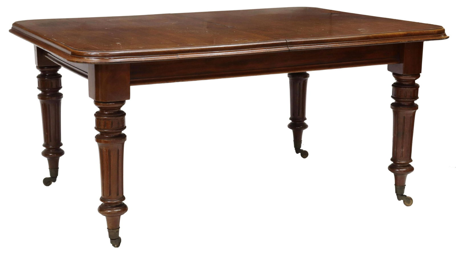 ENGLISH VICTORIAN MAHOGANY DINING TABLE & LEAVES: English Victorian mahogany dining table, 19th c., having rectangular top with rounded corners, molded edge and apron, rising on turned fluted legs, moving on gilt metal casters, hand crank mechanism o
