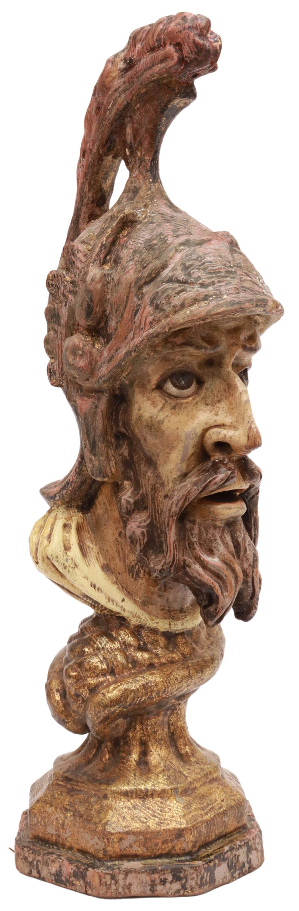 CARVED & PAINTED WOOD BUST, ROMAN SOLDIER, 19TH C.: Carved and painted wood bust, modeled as Roman Soldier, 19th c., having parcel gilt accents, standing on octagonal socle, intact with crack, approx 21.25"h, 7"w, 7"d, 4.25lbs Start Price: $200.00