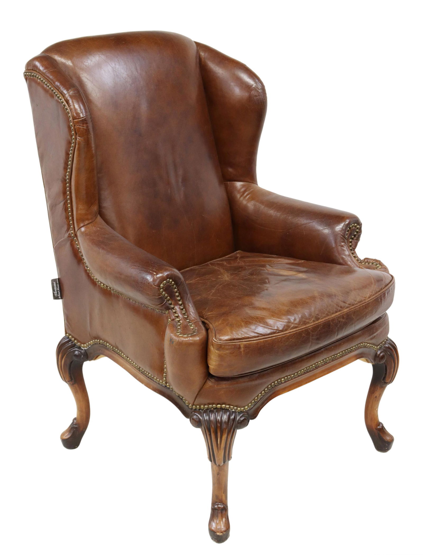 QUEEN ANNE STYLE BROWN LEATHER WINGBACK CHAIR: English Queen Anne style wingback armchair, Artsome for Coach House Collection, 20th c., brown leather upholstery, with nailhead trim, rising on carved cabriole legs, approx 44"h, 28"w, 30"d, seat hei
