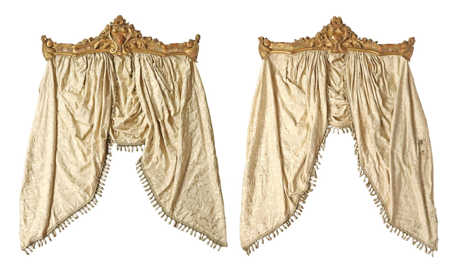 (2) FRENCH LOUIS XV STYLE GILDED & DRAPED VALENCES: (pair) French Louis XV style gilded and painted valences, 19th c., having elaborate carved foliate and cartouche crest, with carved acanthus leaf end caps, hung with tasseled damask drapery, some dark