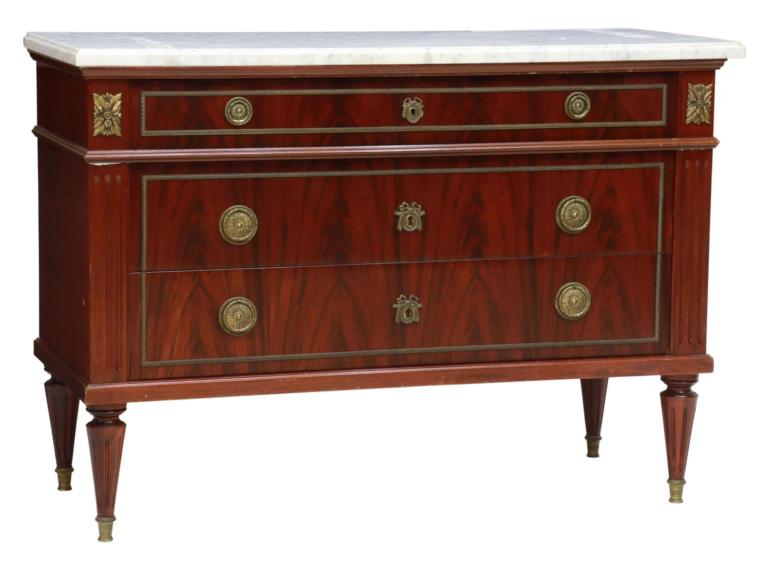 FRENCH LOUIS XVI STYLE MARBLE-TOP MAHOGANY COMMODE: French Louis XVI style marble-top mahogany commode, 20th c., rectangular case fitted with three drawers, rising on tapered fluted legs, ending in metal-capped feet, approx 33.5"h, 47.5"w, 19.75"d Star