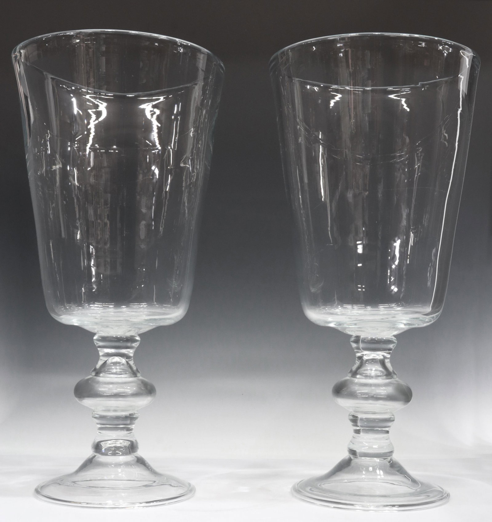 (2) BELGIAN GOMMAIRE CLEYBERGH GLASS VASES, 21"H: (pair) Belgian colorless art glass vases, Gommaire Cleybergh, 21st c., tapered vessel, rising on a pedestal foot, acid-etched mark, approx 21"h, 10"diam; 23lbs total Start Price: $100.00