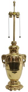 ASIAN BRASS URN MOUNTED AS A TWO-LIGHT TABLE LAMP: Asian brass urn, now mounted as a two-light table lamp, Marbro Lamp Company, 20th c., urn form, with elephant head handles at either side, rising on lotus-form base, maker's tag between light fixtures