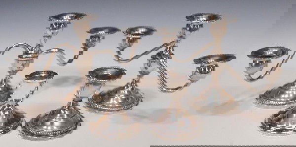 PAIR FISHER STERLING SILVER WEIGHTED CANDELABRA: (lot of 4) (pair) Fisher weighted silver three-light candelabra, curving arms, 6"h, 10"w; together with (1) Fisher weighted sterling short candle holder, denting/wear, 3.5"h; and (1) Duchin weighted s