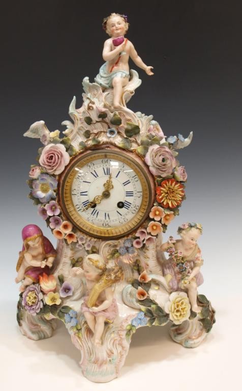 SITZENDORF ALLEGORIGAL PUTTI PORCELAIN CLOCK: Large German allegorical porcelain mantle clock, Voigt Bros., Sitzendorf Porcelain Manufactory, Thuringia, four scantily clad putti representing the four seasons mounted on the elaborate case complete