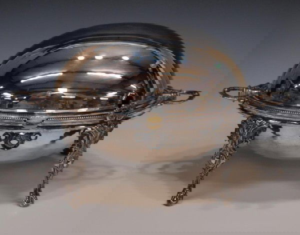 ORNATE SHEFFIELD PLATE DOMED WARMING DISH: English silver plate domed warming dish, William Hutton & Sons, Sheffield, the oval dish concealing a pierced insert, rising on four ornate legs, 9.5"h, 15"w, 7lbs