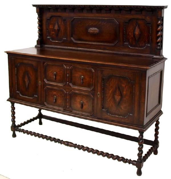 FINE EDWARDIAN CARVED OAK BARLEY TWIST SIDEBOARD: English Edwardian oak sideboard raised on a barley twist stretcher base, terminating in elongated bulb feet, 55"h, 60"w, 21"d