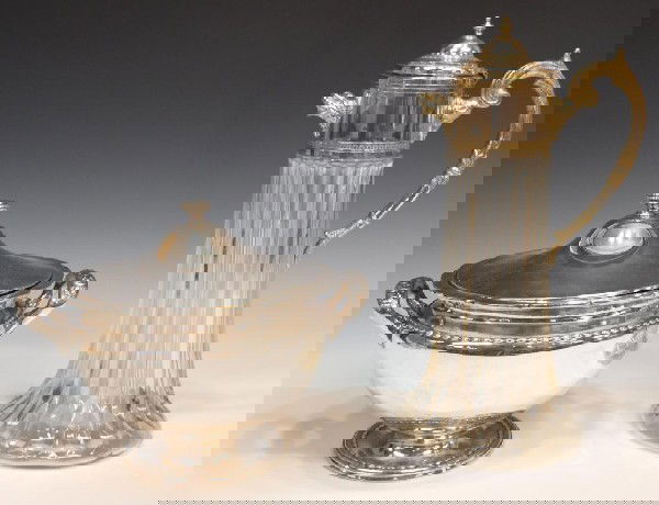 ST. LOUIS SILVER PLATED TUREEN & LARGE CLARET JUG: (lot of 2) Silver plate service items including: (1) large footed soup tureen with handles, St. Louis Silver Company, 9"h; (1) cut glass and silver claret, handled with lid and figural spout, 14"h; 8l