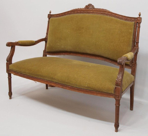 LOUIS XV STYLE CARVED WALNUT UPHOLSTERED SETTEE: French settee in the style of Louis XVI, c. 1910, padded upholstery on the acanthus carved walnut frame, rising on simple supports, 39"h, 50"w, 23"d