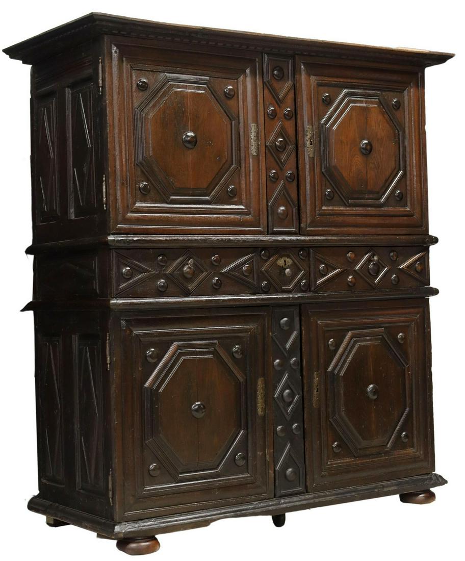 FRENCH LOUIS XIII OAK CUPBOARD, 18TH C.: French Louis XIII oak cupboard, 18th c., dentil molded cornice, four paneled doors, framing three medial drawers, rising on large bun feet, approx 75"h, 66"w, 29.5"d Start Price: $500.00