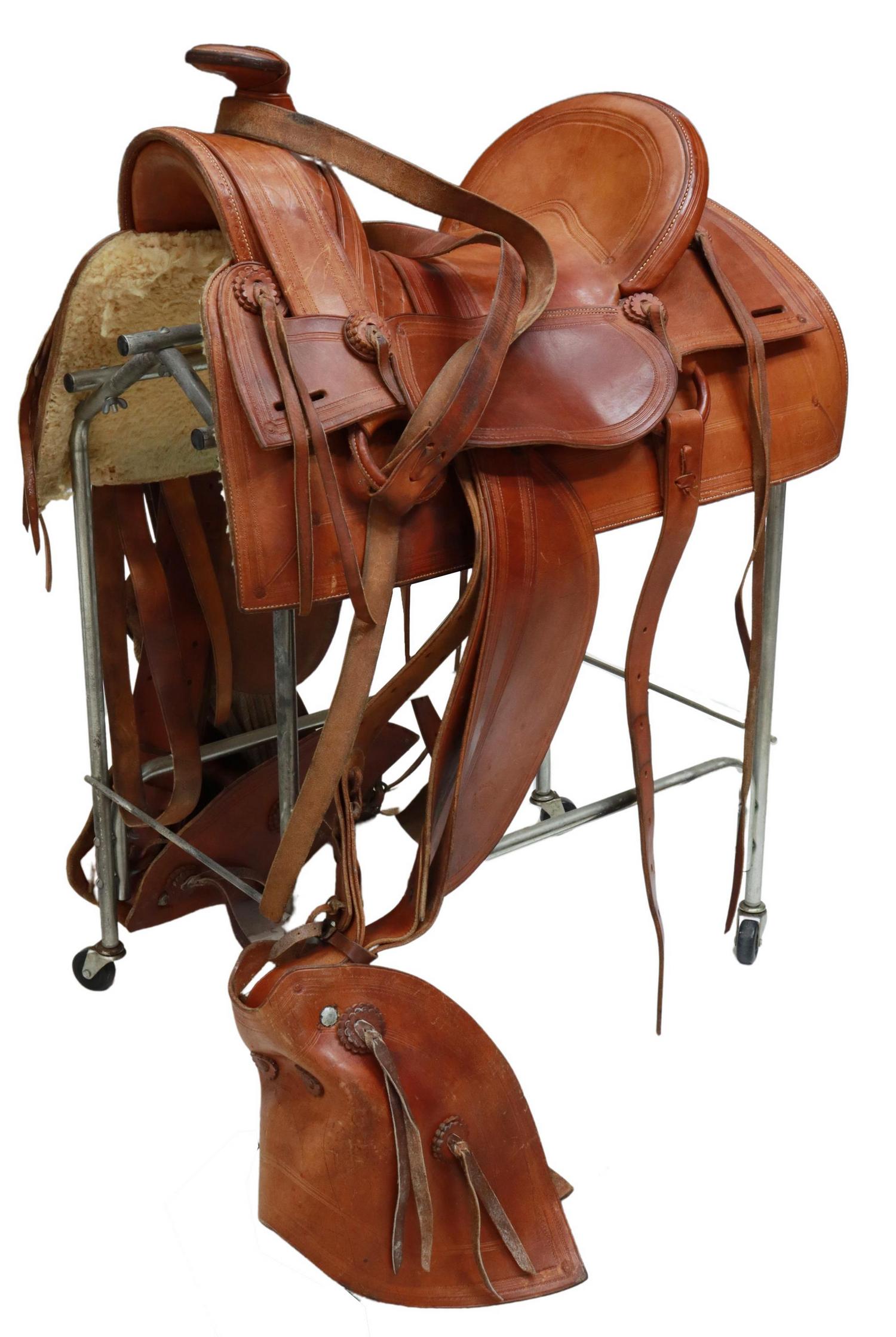 WESTERN J&C STEWART, SHOW LOW, ARIZONA SADDLE: Western brown leather saddle by J&C Stewart, Show Low, Arizona, 17" seat, tooled tapaderos Start Price: $150.00