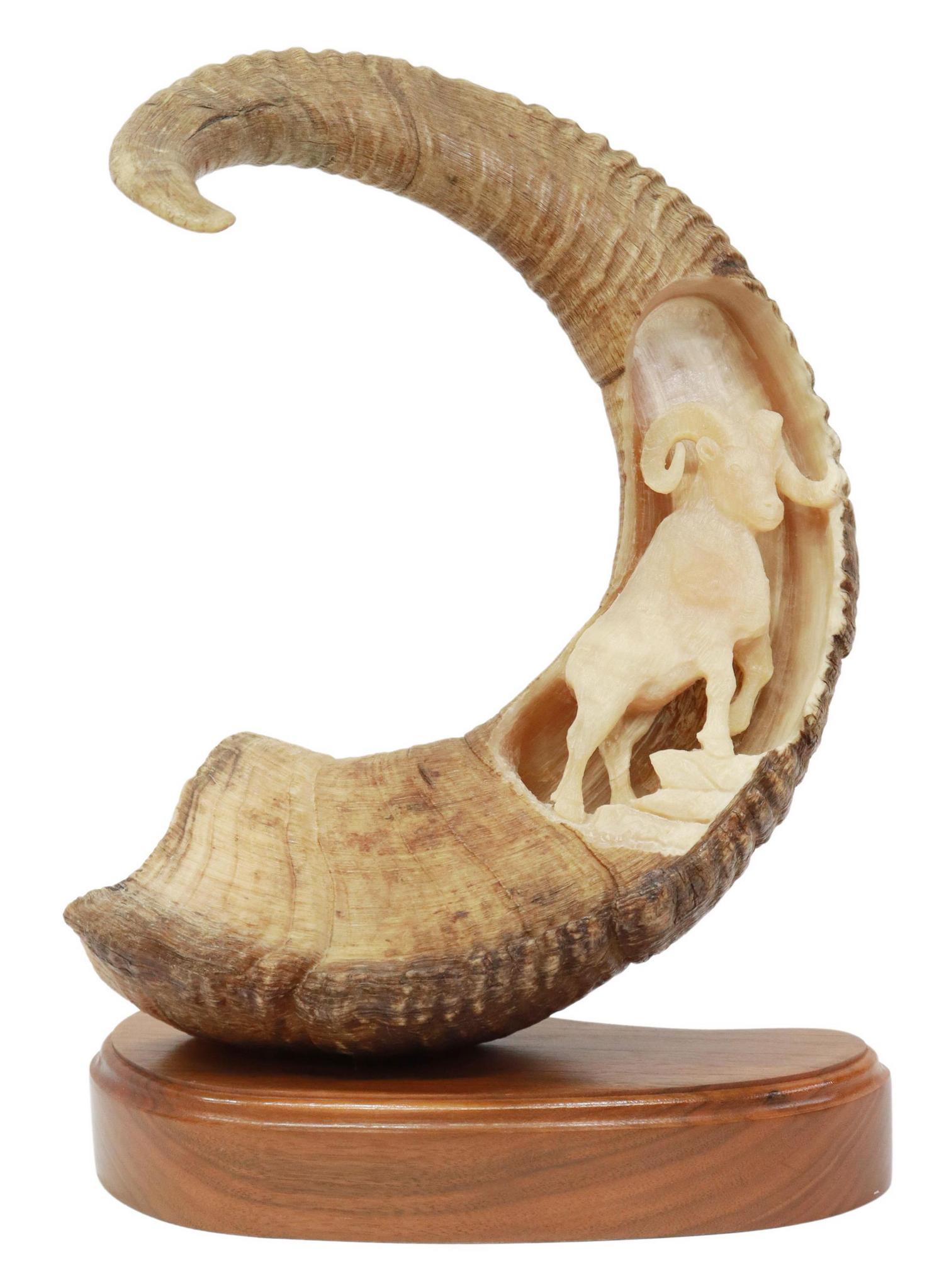 BOB MERRY RAM HORN CARVED WITH FULL BODY RAM: Ram sheep horn carved at the interior of one side with a three dimensional depiction of a full body ram approx 6"l, the entire horn approx 32"l, signed "B. Merry, Anchorage, Ak," (Bob Merry, Bob Merry