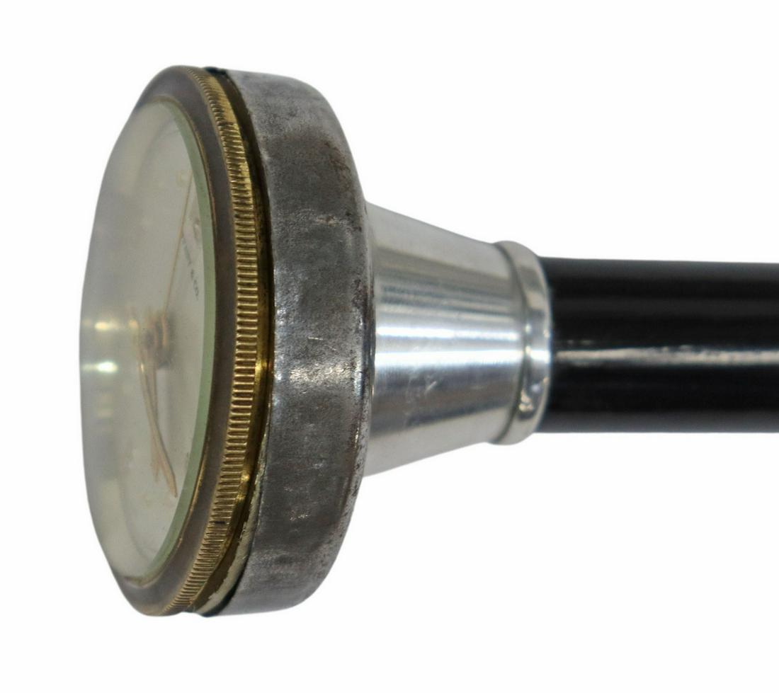 TIFFANY & COMPANY MARKED WATCH WALKING STICK: Walking stick with watch handle, the face marked Tiffany & Co., 8 Days, Swiss Made", watch observed operating for several days, watch has an alarm which is not operating, the cane is black with a bras