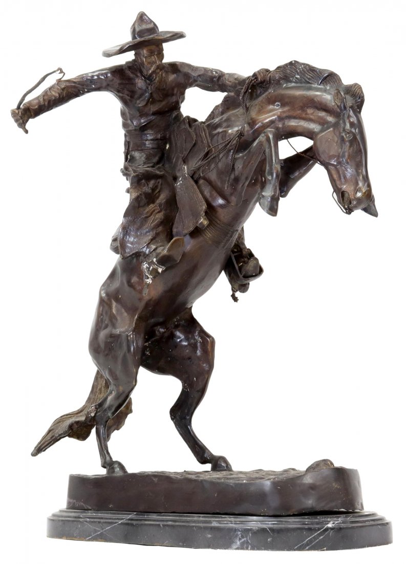 AFTER REMINGTON BRONCO BUSTER BRONZE, 22" x 17": Western patinated bronze sculpture, "Bronco Buster," after the original c. 1895 by Frederic Sackrider Remington (American, 1861-1909), on a black marble base, overall: approx 22.5"h, 17.75"w, 12"d, 38