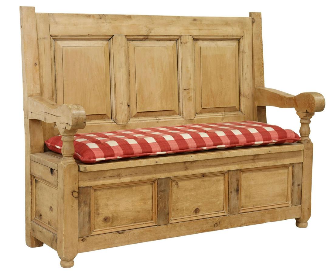 RUSTIC FARMHOUSE PINE SETTLE/ BENCH: Rustic pine farmhouse settle/ bench, 20th c., paneled back, over scrolled arms, removable cushion, hinged seat opening to storage interior, rising on bun feet, approx 45.25"h, 57"w, 21.25"d, seat heig
