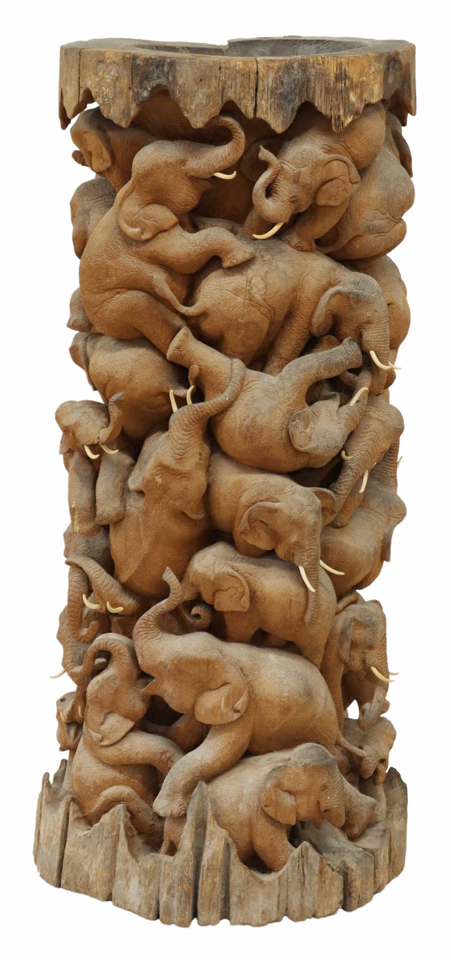 ARCHITECTURAL CARVED ELEPHANTS PLANTER/ PEDESTAL: Architectural pedestal/ planter, carved from a single piece of wood, with hollowed dish top, exterior completely carved with elephants in relief, approx 48"h Start Price: $200.00