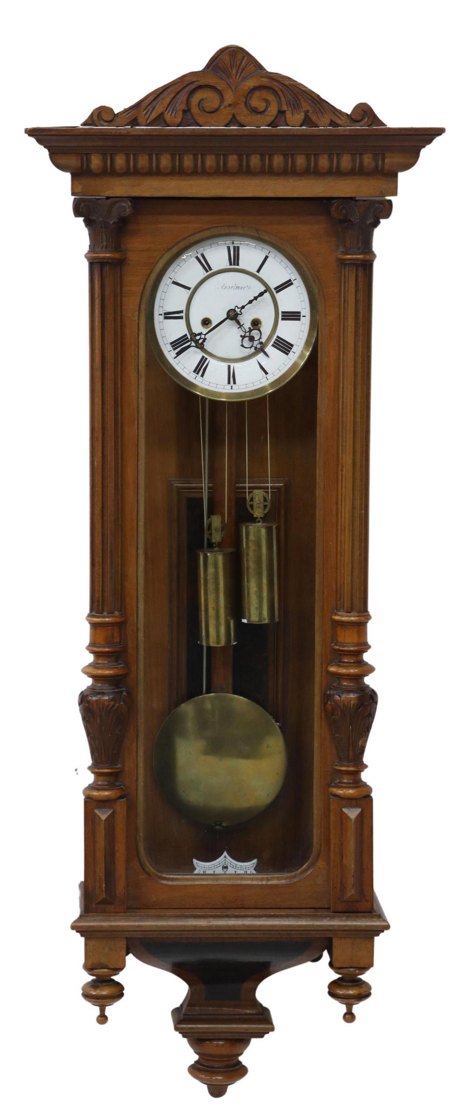 TWIN-WEIGHT REGULATOR WALL CLOCK: Continental regulator wall clock, late 19th/ early 20th c., walnut-finish case with carved crest, turned pilasters, glazed door and side panels, housing white enamel dial with Roman numeral hour marke