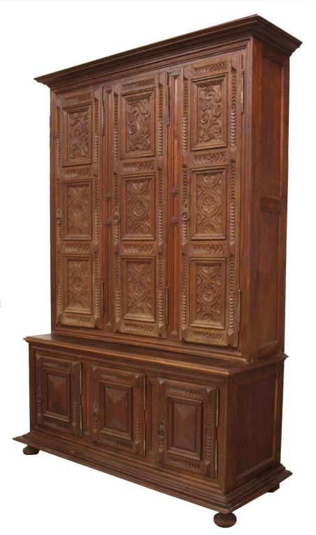 HUGE FRENCH ANTIQUE CARVED FRONT BOOKCASE: Huge French oak carved front two part bookcase, c. 1890, the upper case having three foliate carved long doors, the lower part with three short doors, all resting on block and bun feet, 104"h, 67"w, 2