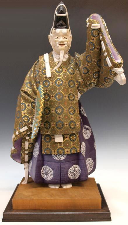 FINE JAPANESE CARVED WOOD NOH DRAMA FIGURE DOLL: Japanese carved wood Noh drama performer, Okina, finely detailed figure of a man in traditional dress with kabuki mask and head piece, polychrome painted with gilt painted accents, exquisite detail do