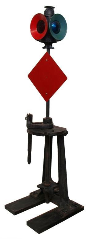ANTIQUE RAILROAD SWITCH STAND & FOUR WAY LAMP: Iron railroad switch stand by Elliot F&S (frog and switch) Company, c. 1915, with mounted four way Handlan green and red signal lantern, electrified for use as floor lamp, 83"h, 22"w, 24"d Start Price