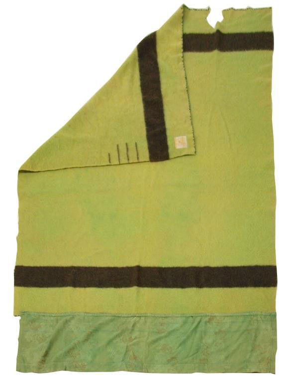VINTAGE HUDSON'S BAY COMPANY WOOL BLANKET: Vintage Hudson's Bay Company wool blanket, 3.5 point (twin size), green with black bar and points, tag present with minor moth wear, home-made footer added to allow blanket to be tucked in, 1936-1940s