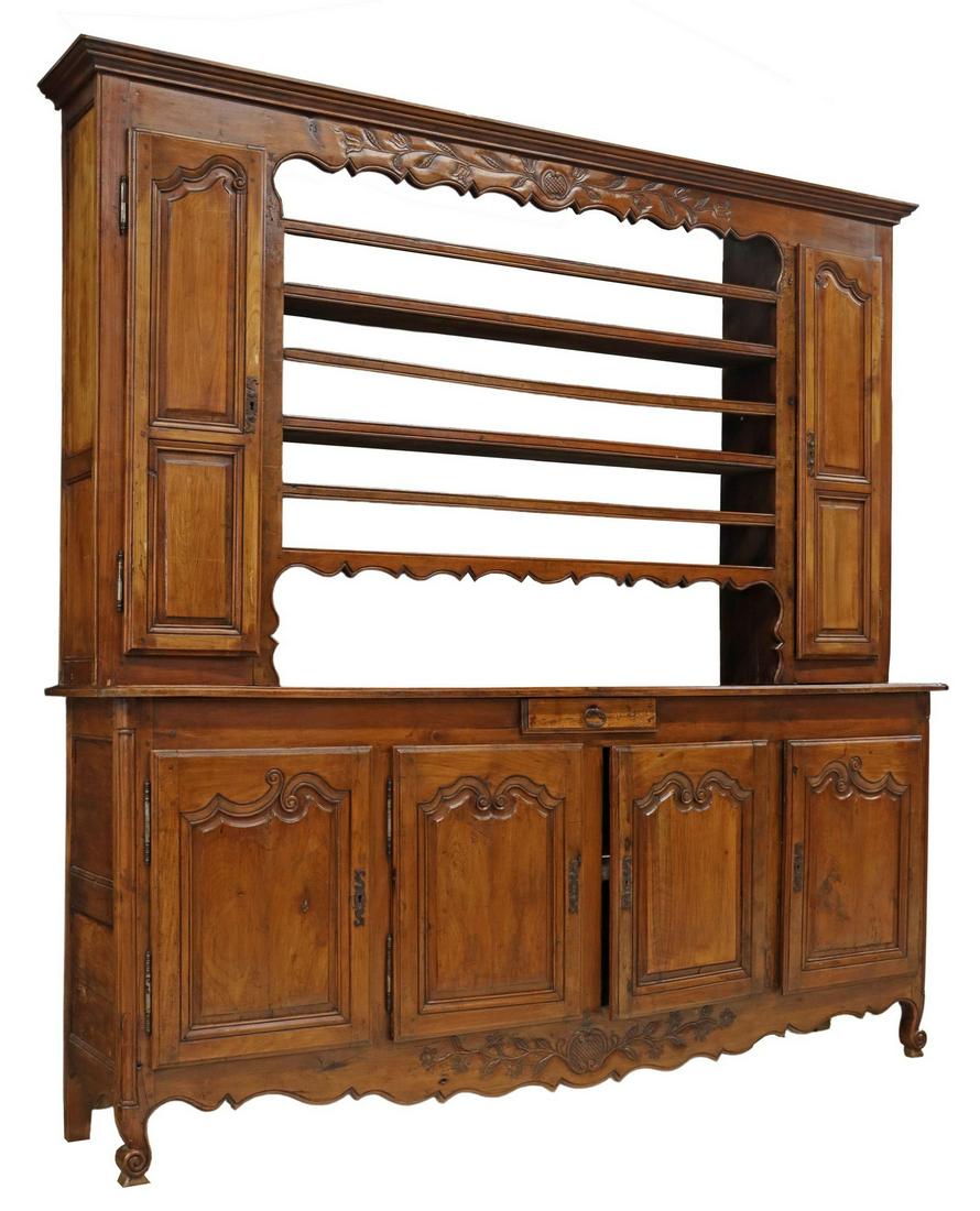 FRENCH PROVINCIAL FRUITWOOD VAISSELIER, 19TH C.: French Provincial Louis XV style fruitwood vaisselier, 19th c., molded cornice, frieze carved with stylized flowers, two upper cabinet doors, framing open shelves with plate grooves, lower case fitted