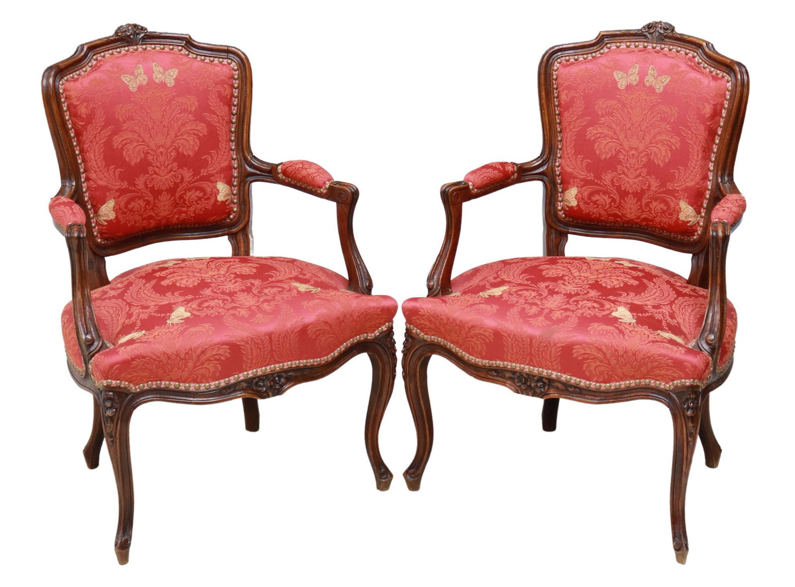 2) FRENCH LOUIS XV STYLE OAK UPHOLSTERED FAUTEUILS: (pair) French Louis XV style oak armchairs, late 19th c., carved floral crest, in floral damask upholstery with butterflies and nailhead trim, rising on cabriole legs, ending in whorl feet, approx 34.
