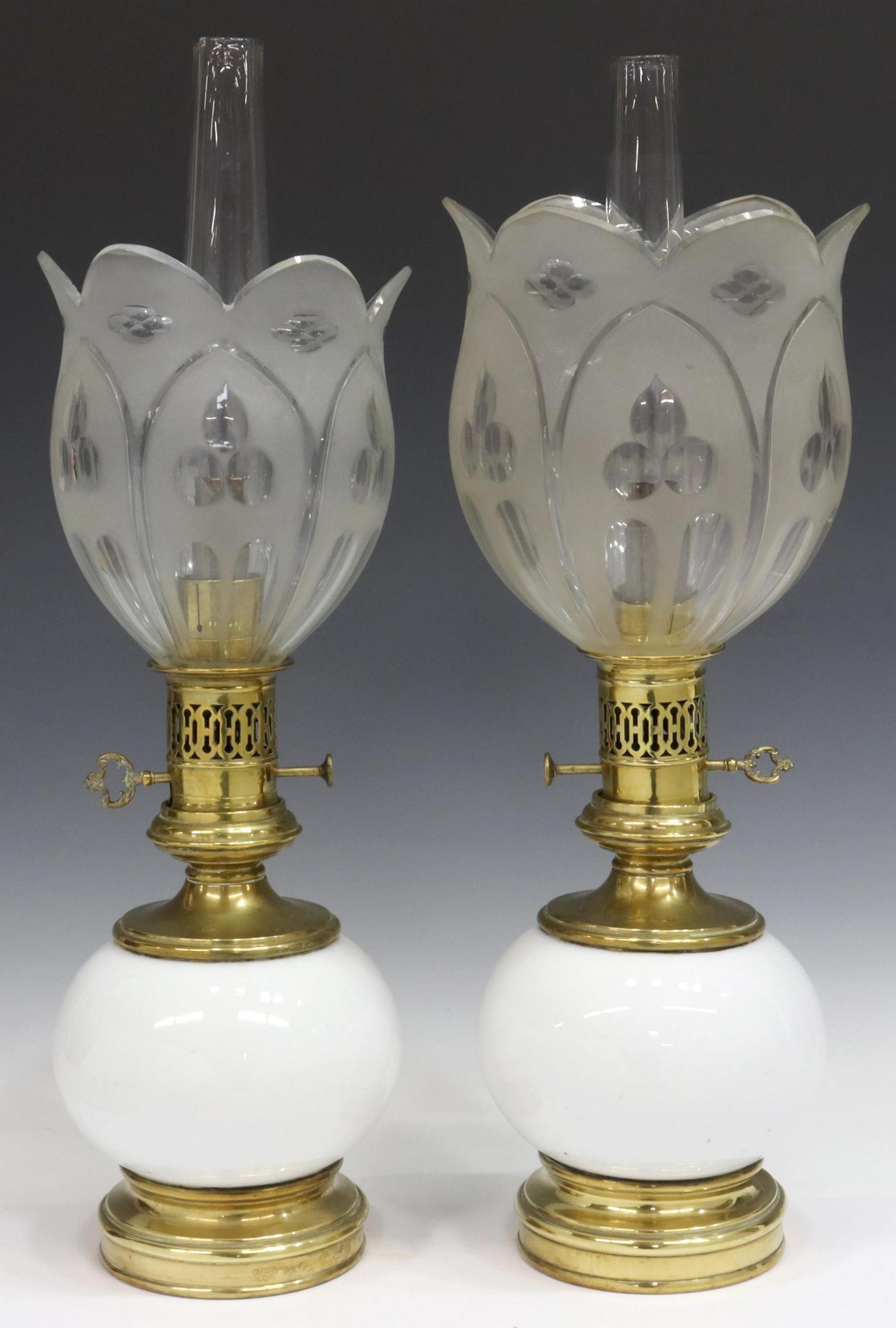 (2) NAPOLEON III STYLE PORCELAIN & BRASS OIL LAMPS: (pair) French Napoleon III style porcelain and brass oil lamps, late 19th c., each having colorless glass chimney, above frosted glass shade, shades vary in size, over white porcelain body, rising on 
