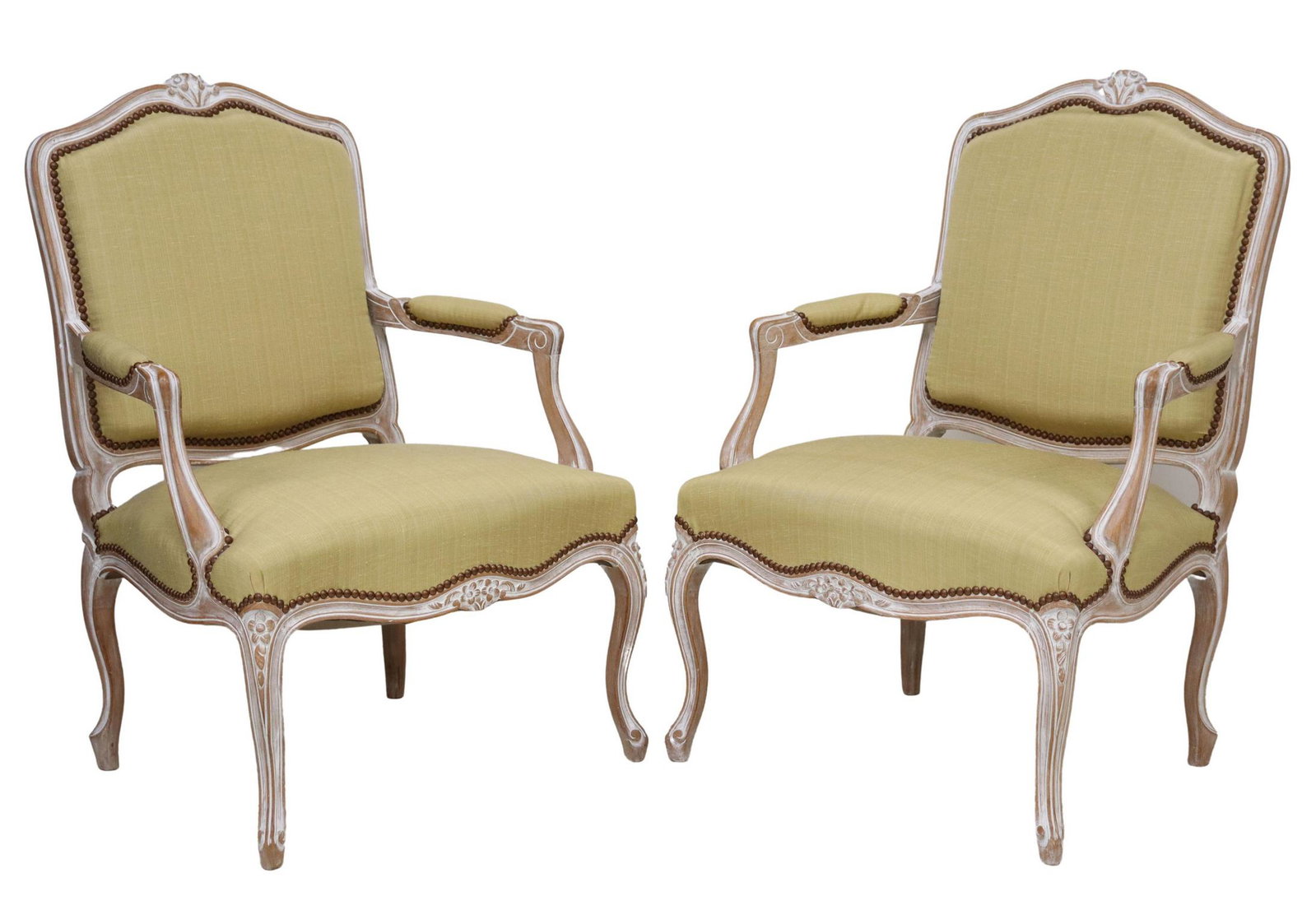 (2) FRENCH LOUIS XV STYLE UPHOLSTERED FAUTEUILS: (pair) French Louis XV style armchairs, 20th c., whitewashed frame with carved floral crest, upholstered back, arms, and seat, accented with tack trim, rising on cabriole legs, approx 37.25"h, 26.5"w,