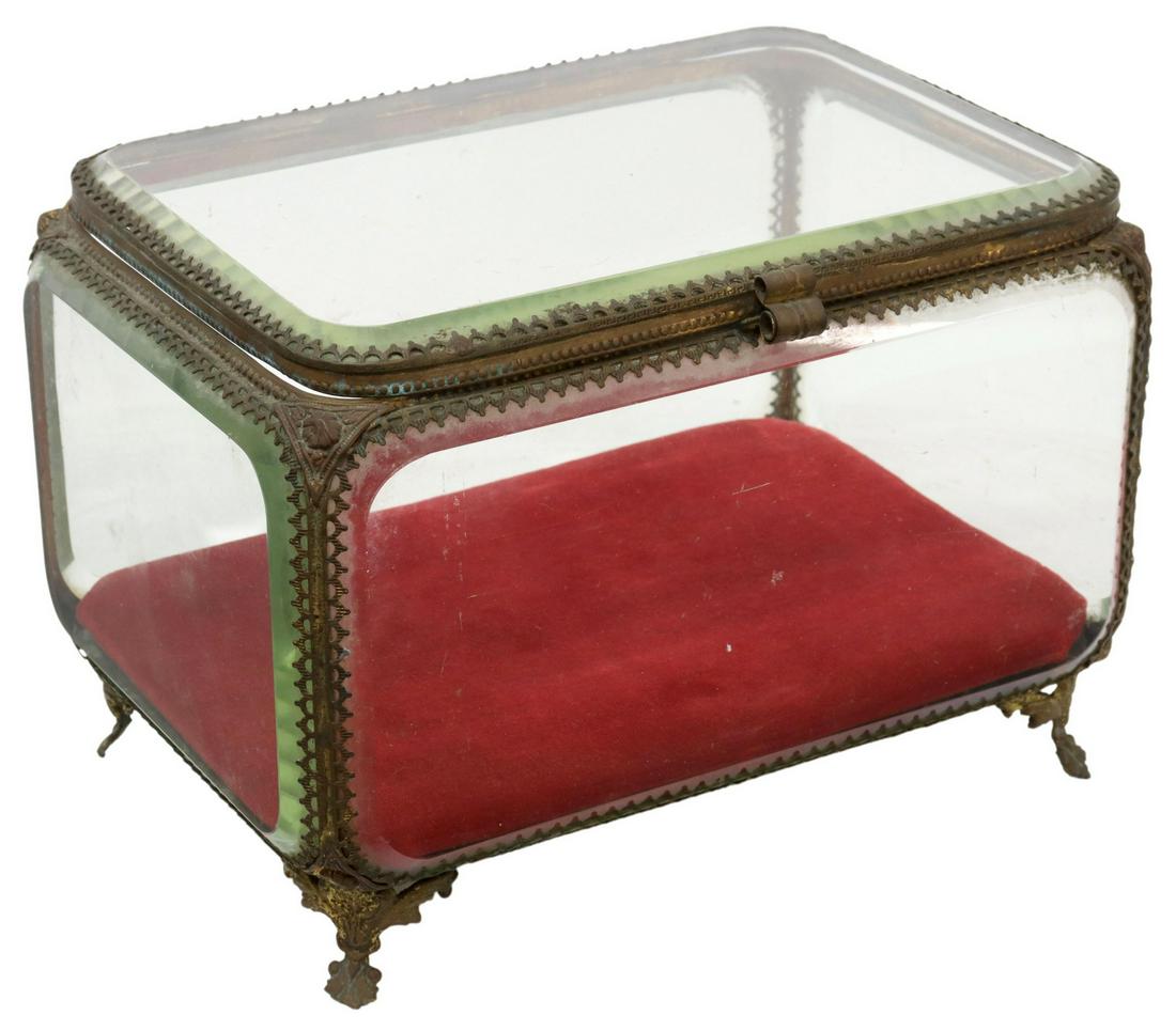 FRENCH GILT METAL & BEVELED CRYSTAL JEWEL CASKET: French gilt metal jewel casket, late 19th c., with beveled glass insets, red velvet base, rising on cast foliate feet, approx 6.5"h, 9"w, 6.25"d, 4.25lbs Start Price: $60.00