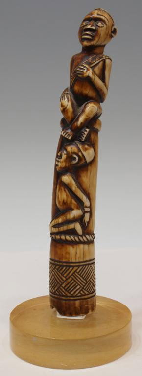 FIGURAL CARVED AFRICAN IVORY TUSK TRUMPET: **International shipping is not available for this item. This item will only be shipped within the United States.** Carved African ivory tusk, the trumpet modeled as seated male and kneeling female fi