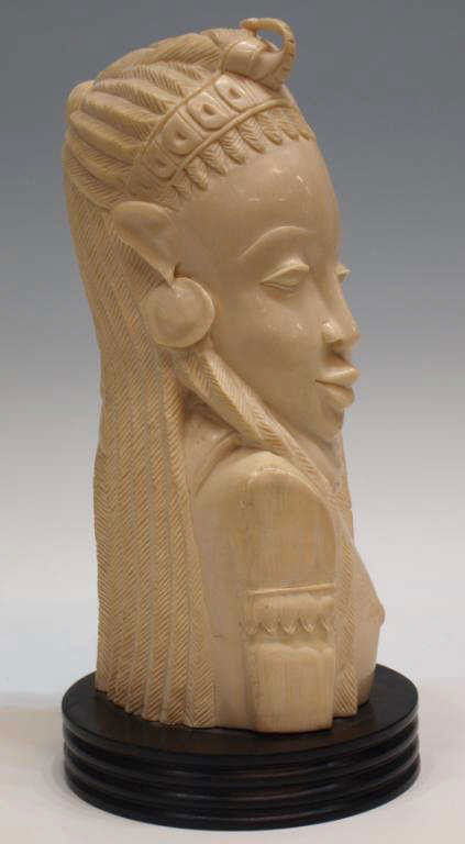 LARGE AFRICAN CARVED IVORY TRIBAL BUST: *Note-This items will not be shipped Internationally** This item will only be shipped within the United States* Large African carved ivory bust, the tribal figure looking to the right, hollowed form m