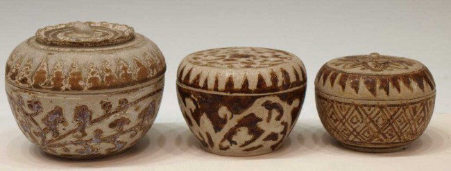 (3) ANTIQUE THAI SAWANKHALOK LIDDED POTTERY BOXES: (lot of 3) Thai Sawankhalok ceramic boxes, 14th/15th c., each of circular form with stylized foliate decoration, brown glaze set on a light grey ground, rim/underfoot chips, largest: 4"h, 1.75lbs tota
