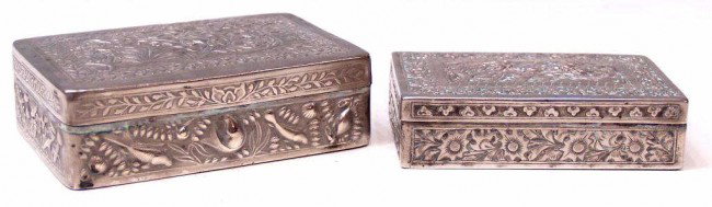 ANTIQUE SINO-THAI REPOUSSE SILVER DRAGON BOXES: (lot of 2) Sino-Thai silver table boxes, each finely worked in relief: (1) profusely decorated with a pair of birds perched amidst flowering vines, side panels showing fish and foliates, 1.25"h, 4.75"