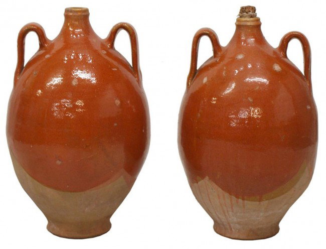 PAIR ANTIQUE SPANISH EARTHENWARE HANDLED JARS: (pair) Spanish earthenware handled vessels, early 20th c., loop handles join the bulbous body of each in a stylized drip glaze, one retaining cork, 23"h, 12"diam., 30lbs total Start Price: $300.00