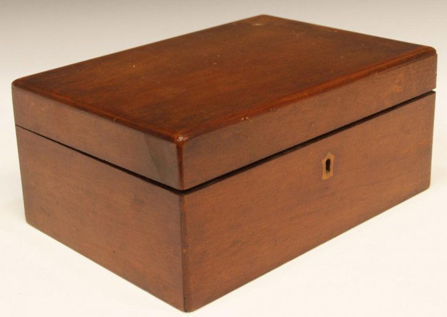 ENGLISH MAHOGANY CARVED JEWELRY BOX: English mahogany jewelry box, rectangular form with rounded edges, inlaid wood at escutcheon, hinged lid opens to removable divided compartment tray, 4.5"h, 10"w, 7"d, 2.5lbs Start Price: $80.00