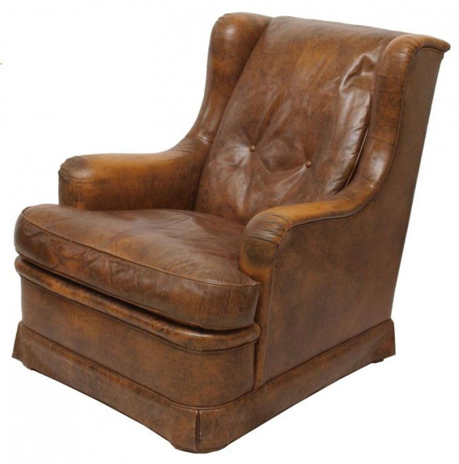 FRENCH LEATHER WING BACK CLUB CHAIR: French leather upholstered club chair, c. 1920, the padded wing back joined to the cushioned seat by scrolled arms, raised on curved block legs, wear with age, 36"h, 31"w, 33"d Start Price: $100.00