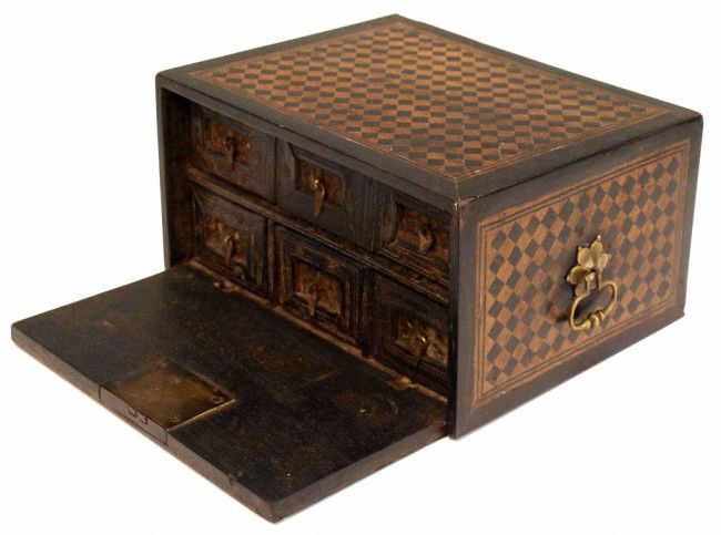 17TH C INDO-PORTUGUESE EBONY INLAID TABLE CABINET: Indo-Portuguese parquetry contador box, 17th c., the teakwood box banded and decorated with inlays of ebony, the fall front door opening to reveal a long drawer over a set of smaller drawers, each fac