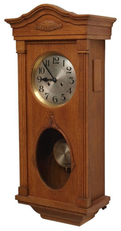 OAK CASED CHIMING WALL CLOCK, OPERATING: Golden oak cased wall clock, German, c. 1900, having metal face, time and strike chiming works, operating, 32"h, 14"w, 8"d, 20lbs Start Price: $100.00