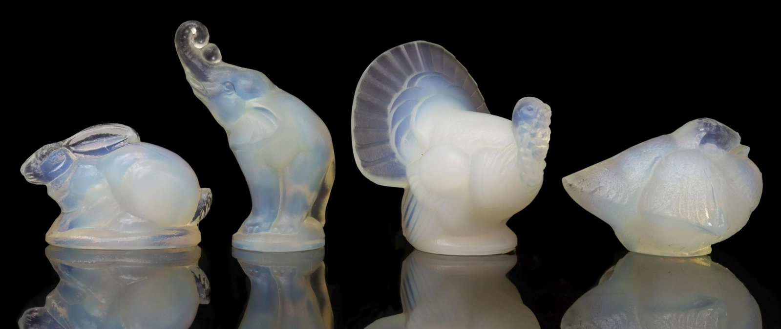 (4) FRENCH SABINO ART GLASS ANIMAL FIGURES: (lot of 4) French opalescent art glass animal figures, Sabino, Paris, all with maker's mark underfoot, including: (1) elephant with ball, (1) rabbit, (1) turkey, chip to beak, (1) bird; largest: appro