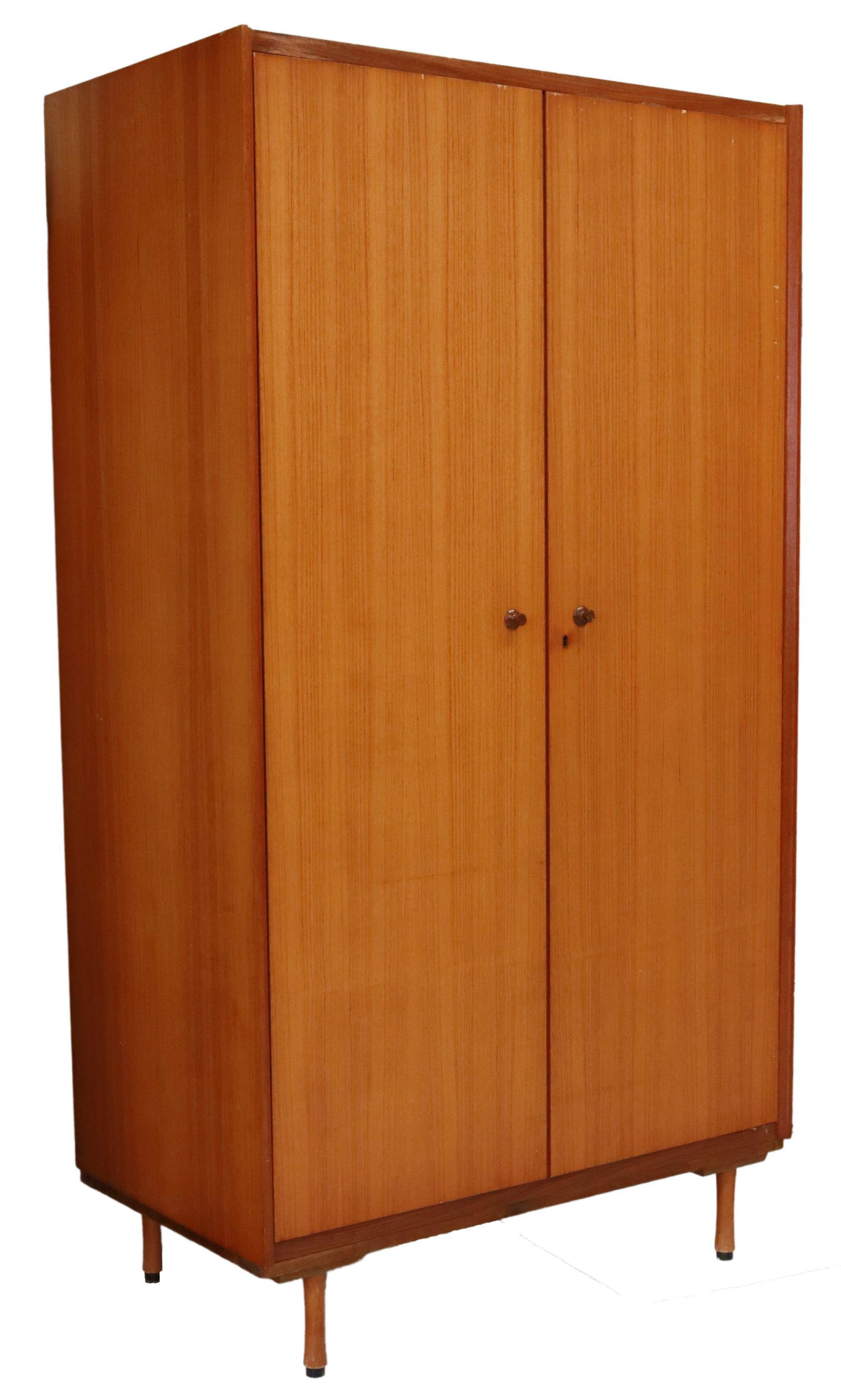 ITALIAN MID-CENTURY MODERN TEAK ARMOIRE WARDROBE: Italian mid-century modern teak wardrobe/ armoire, c.1960s, two doors opening to hanging bar, interior shelf, rising on cylindrical legs, approx 75.5"h, 41.5"w, 23.5"d Start Price: $200.00