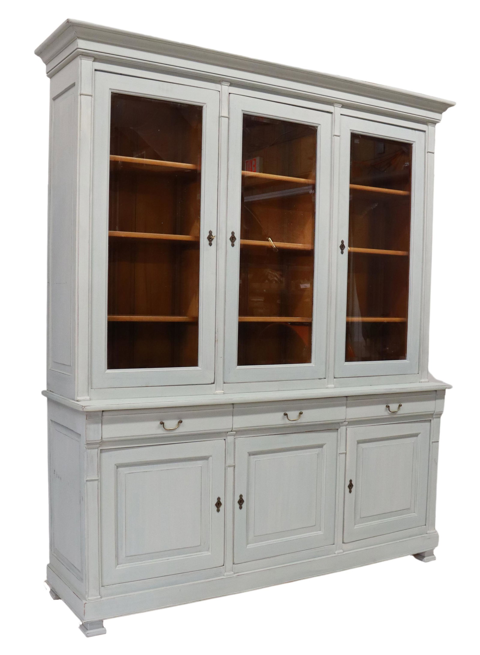 LARGE FRENCH PAINTED STEPBACK BOOKCASE: Large French stepback bookcase, Prestige Ameublement, late 20th c., in a later painted finish, molded cornice, upper doors with beveled glass insets, adjustable-height shelves, lower case fitted with 