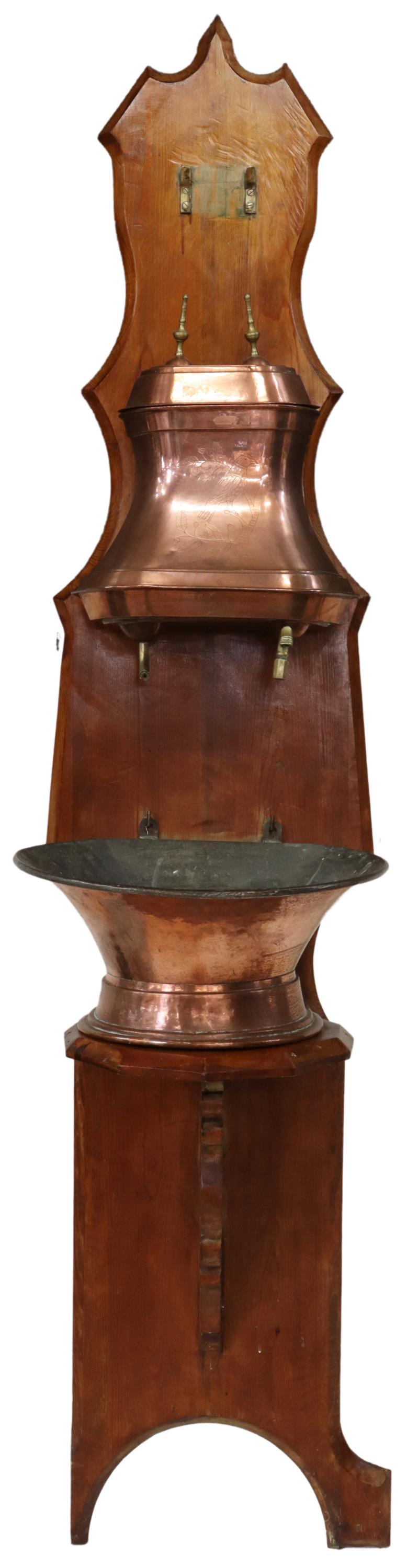 FRENCH PROVINCIAL COPPER LAVABO FOUNTAIN: French Provincial copper lavabo fountain, late 19th c., lidded copper vessel with brass finials, engraved bird perched on oak branches, initialed C.L., two brass spigots over copper basin, all mounted