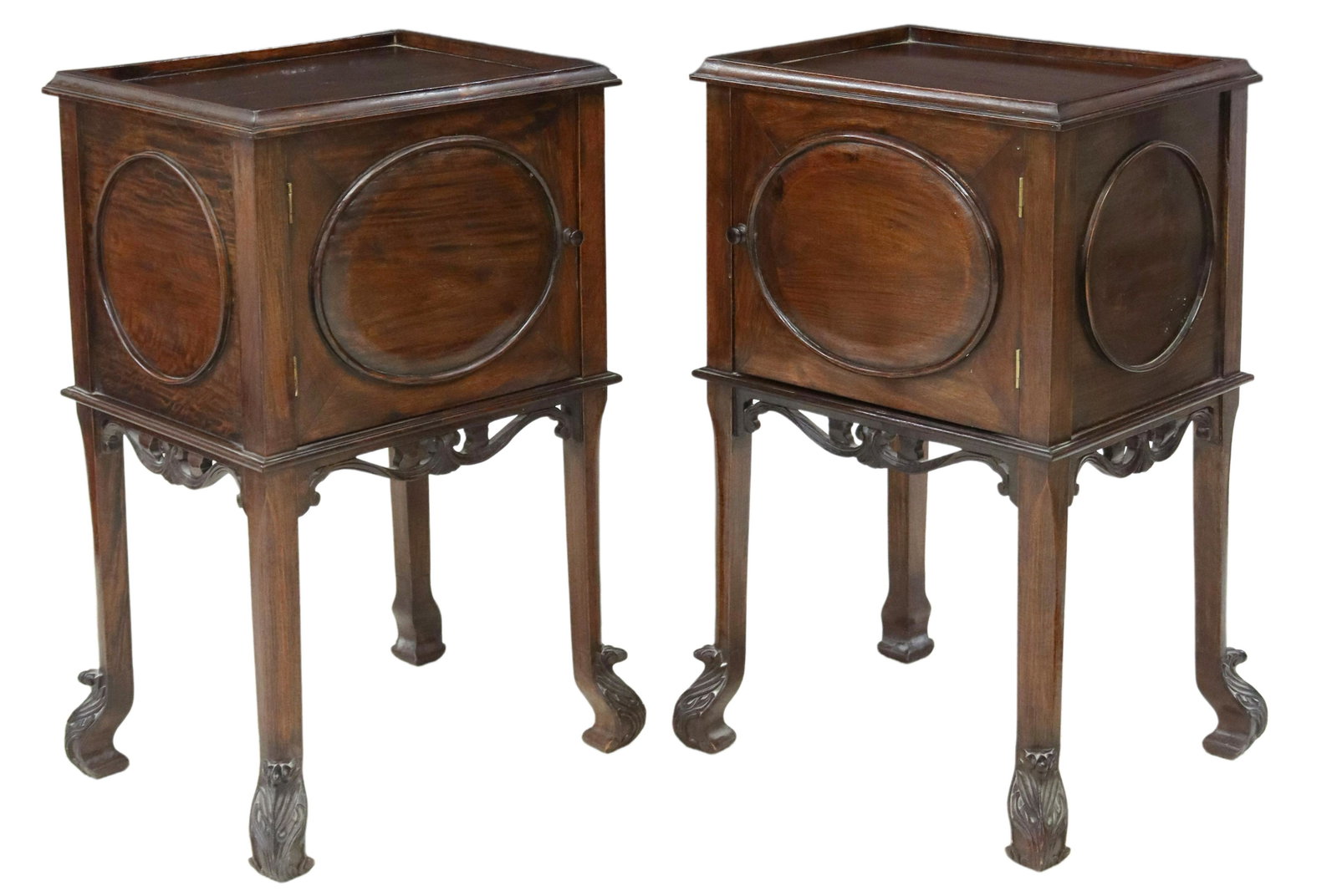 (2) ENGLISH MAHOGANY BEDSIDE CABINETS: (pair) English mahogany bedside cabinets, 20th c., recessed rectangular top, over single cabinet, opening to storage interior, front and sides with molded round panels, carved scrolled apron, rising o