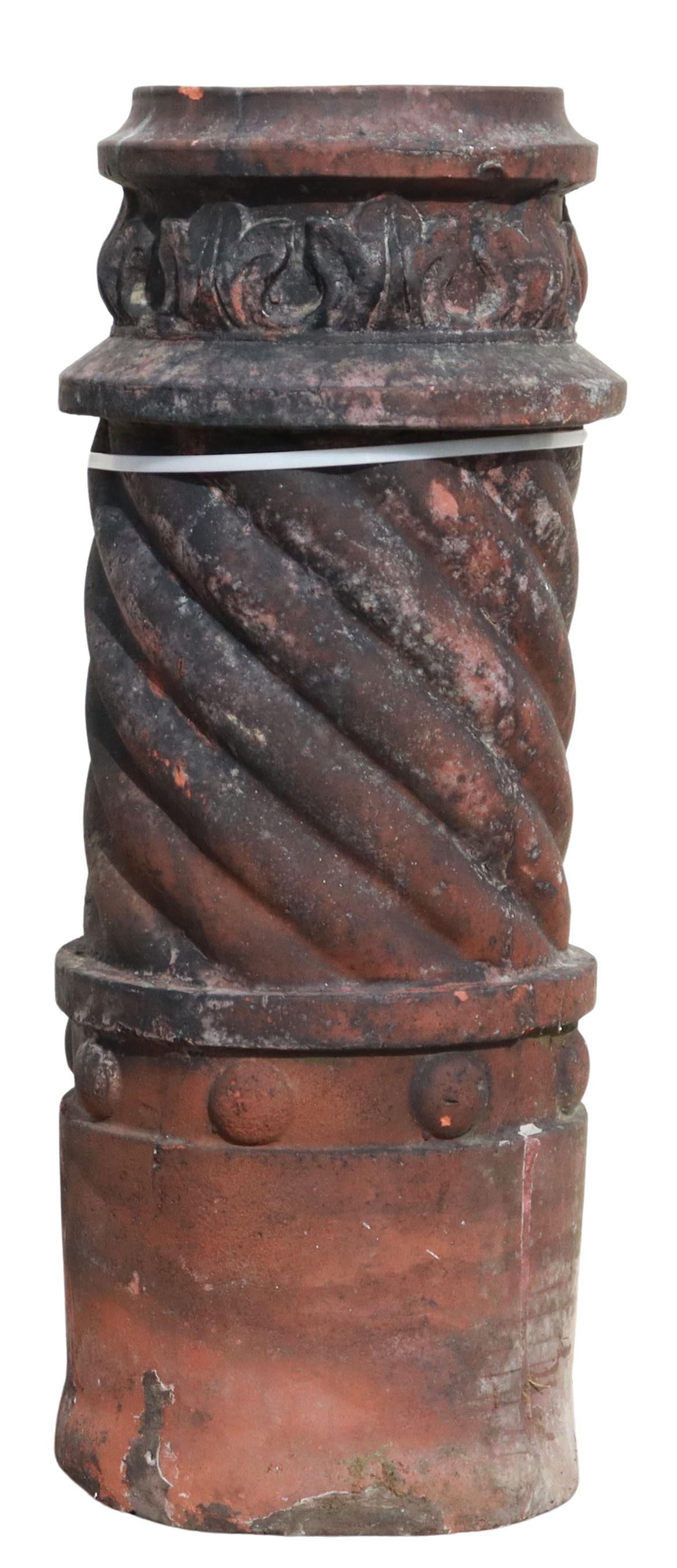 TERRACOTTA ACANTHUS LEAF & TWIST-FORM CHIMNEY POT: Terracotta cylindrical chimney pot, late 19th c., acanthus leaf border, over twisted body, intact with some chips and hairlines, approx 32.5"h, 13"diam **PLEASE NOTE: All of the cast stone and garden