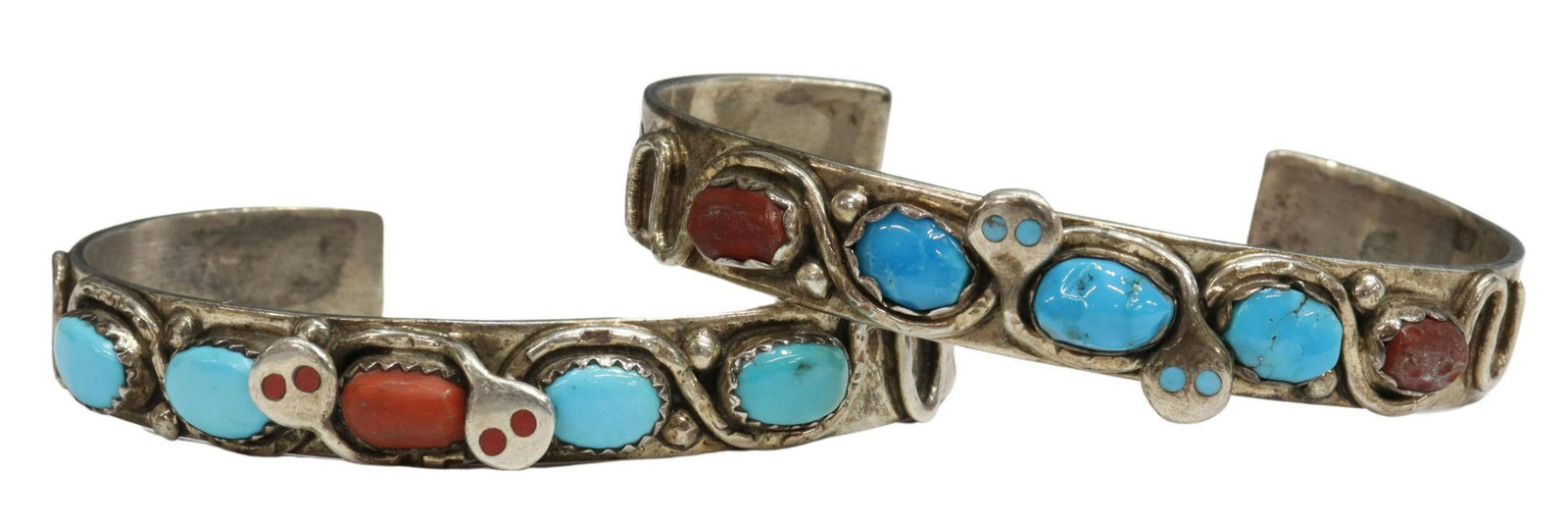 2) EFFIE CALAVAZA ZUNI SILVER SNAKE CUFF BRACELETS: (lot of 2) Native American silver (content unknown) cuff bracelets, signed Effie C. (Effie Calavaza, Zuni Pueblo, b.1928), each featuring two silver snakes with inlaid eyes of turquoise and red coral,